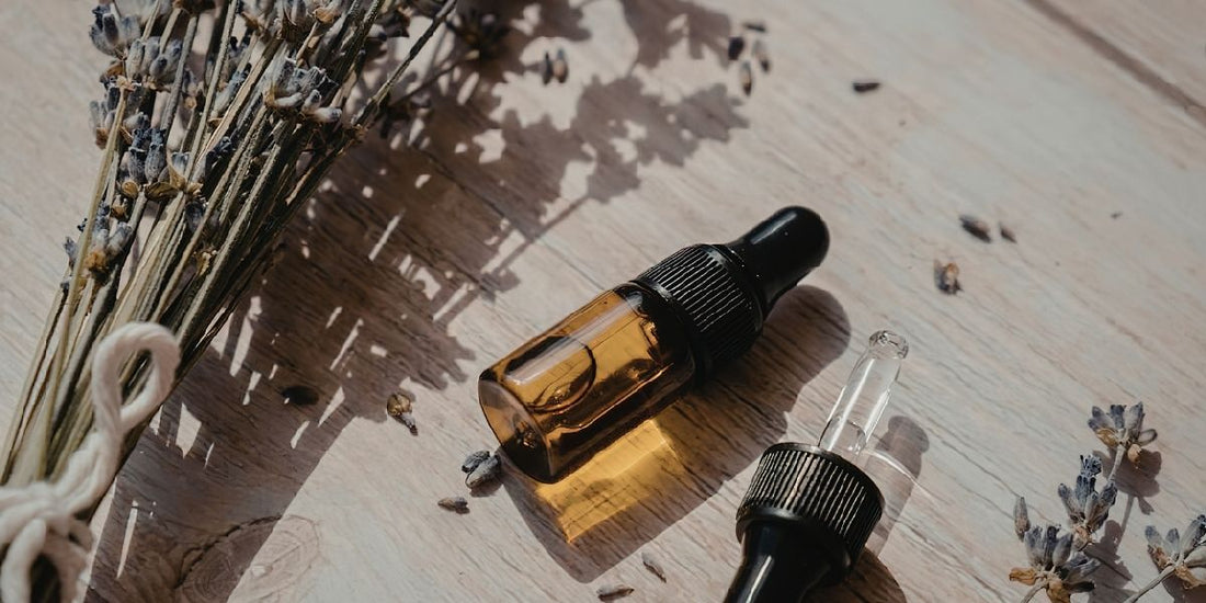 Fragrance oil and essential oil bottles side by side on a clean surface