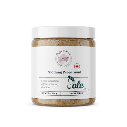 Soothing Peppermint foot scrub in a clear jar with a white lid and green Sole Mate footprint logo.