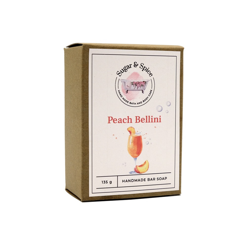 A packaged bar of Peach Bellini handmade soap with the brand name and product title displayed on the label.
