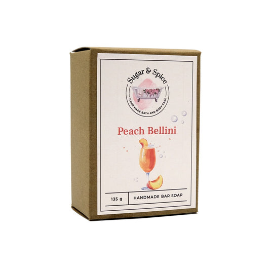 A packaged bar of Peach Bellini handmade soap with the brand name and product title displayed on the label.