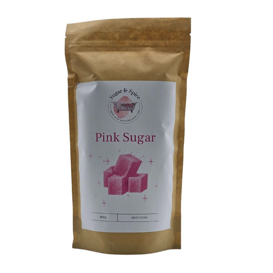 A package of Pink Sugar Bath Soak with a beige background and an image of pink bath salts on the front.