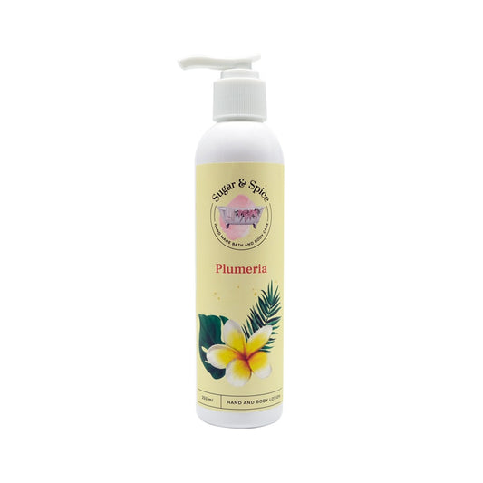 A pump bottle of Sugar and Spice Plumeria Hand and Body Lotion with an image of a plumeria flower on the label.