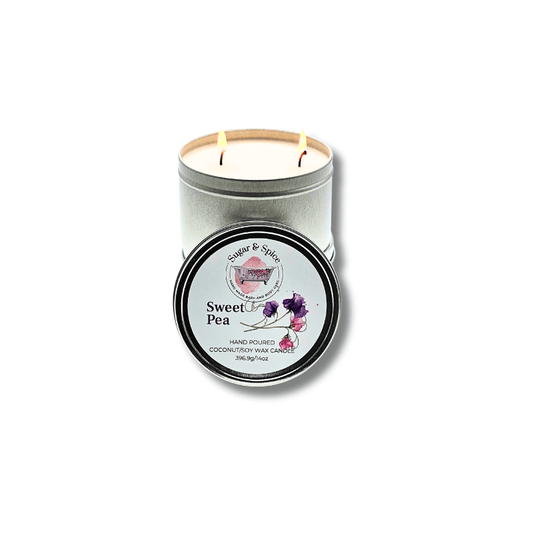 A silver tin container with a two-wick coconut wax candle, labeled 'Sweet Pea' with floral graphics, and a lid on the side.
