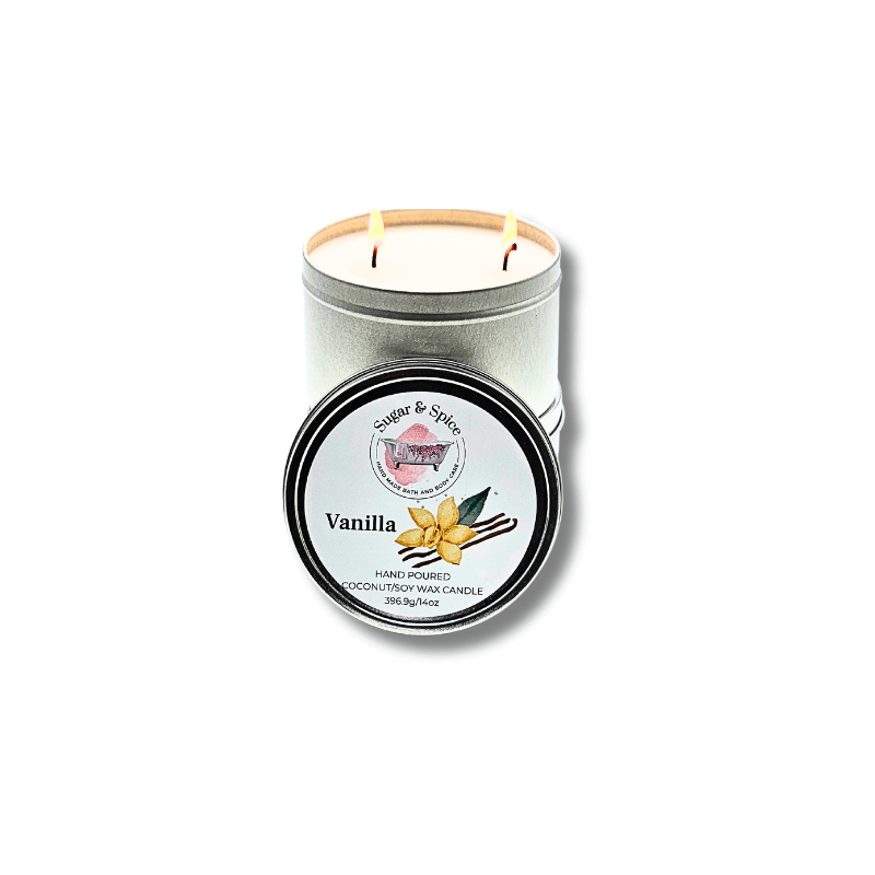 A silver tin container with a two-wick coconut wax candle, labeled 'Vanilla' on the lid.