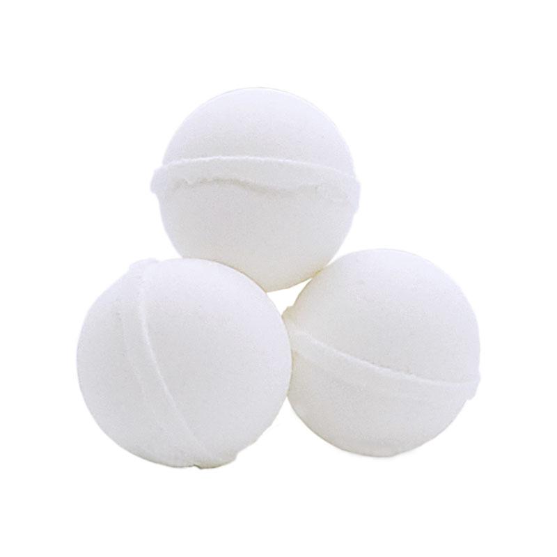 Three white bath bombs designed to resemble birthday cake with frosting on a white background.