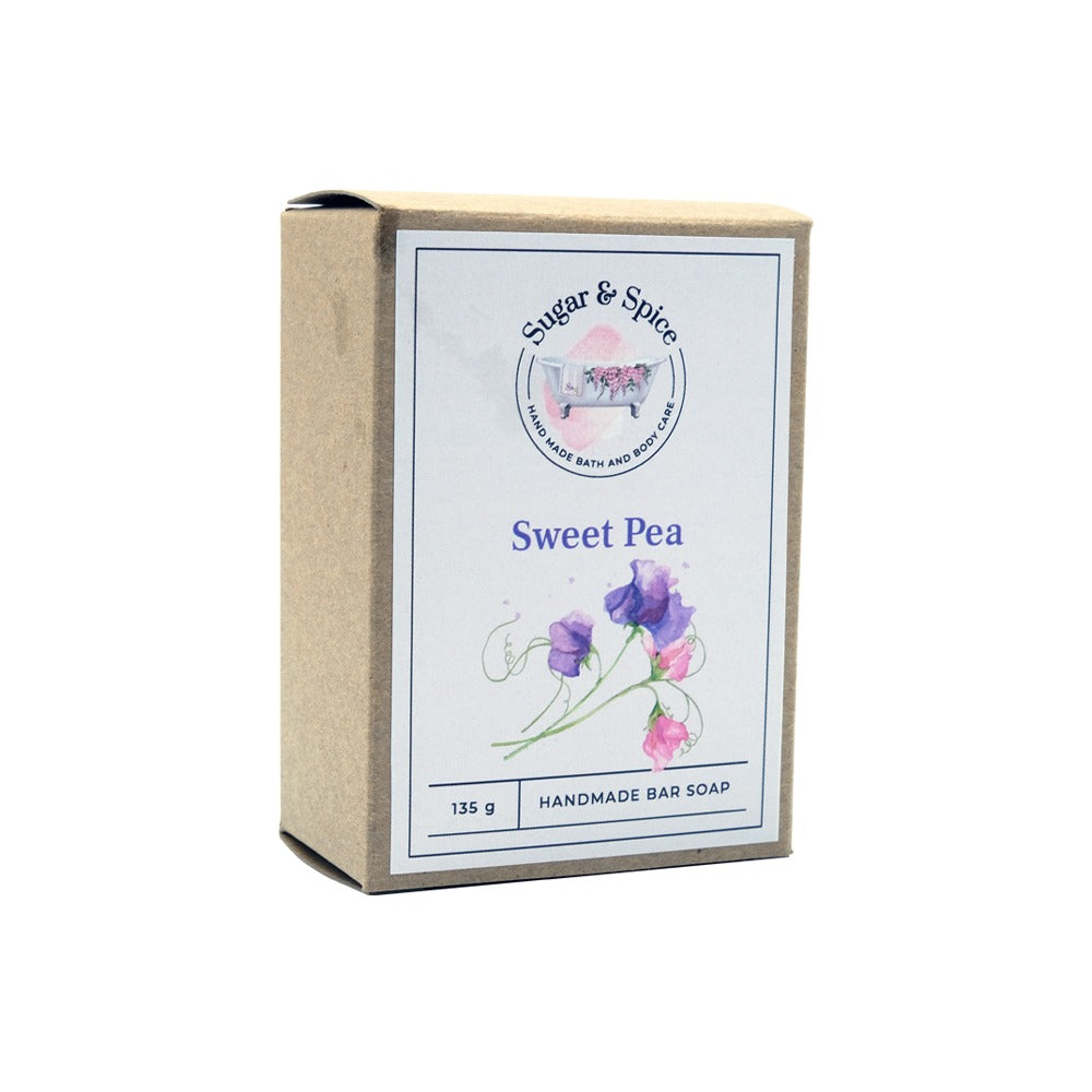 A packaged bar of Sweet Pea handmade soap with the brand name, product name, and weight (115 g) displayed on the label.